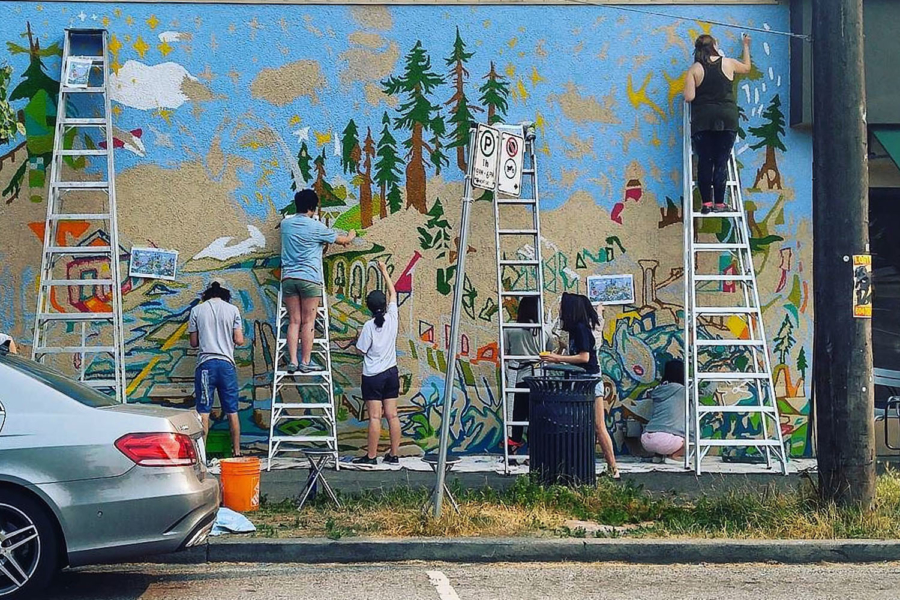 Emily Carr students painting a new mural onto the Marpole Starbucks at West 64th and Granville St.